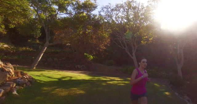 Woman Jogging in Sunlit Park during Morning Exercise - Download Free Stock Images Pikwizard.com