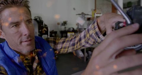 Mechanic Adjusting Motorcycle Handlebar in Workshop