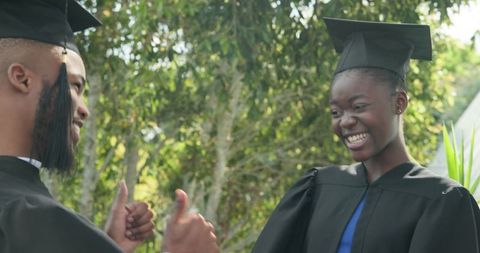 Graduates Celebrating with Joyful Smiles Outdoors