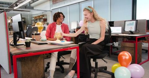 Team Celebration in Modern Office with Balloons and Drinks