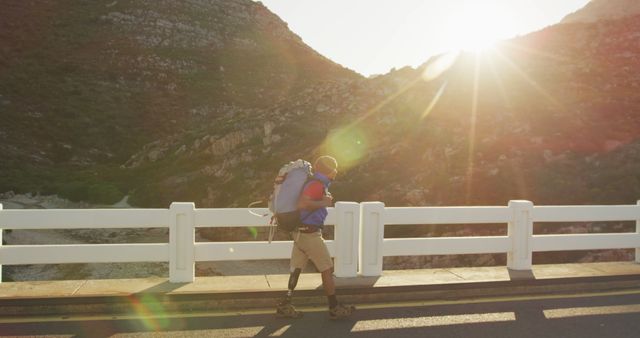 Hiker with Prosthetic Leg Enjoying Sunset on Mountain Road - Download Free Stock Images Pikwizard.com