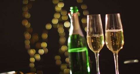 Champagne toast celebration with festive lights