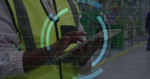 Engineer Using Tablet for Industrial Production Line Monitoring