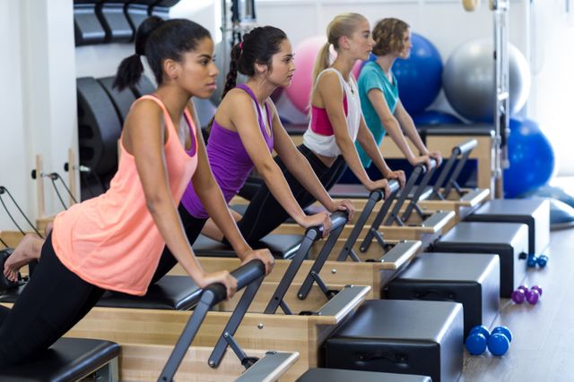 Group of women exercising on reformer - Download Free Stock Photos Pikwizard.com