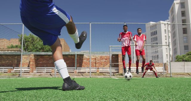 Diverse male football teams, playing match together on outdoor pitch - Download Free Stock Photos Pikwizard.com