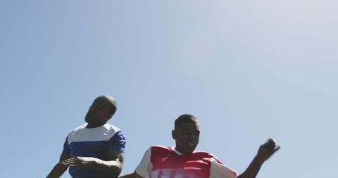 Diverse Football Players Competing for Ball During Match