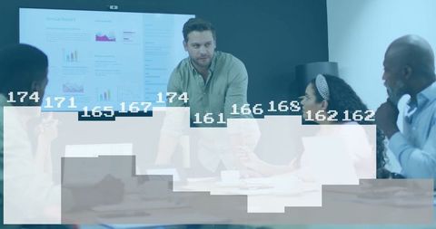 Team Analyzing Data Projections in Corporate Meeting Room