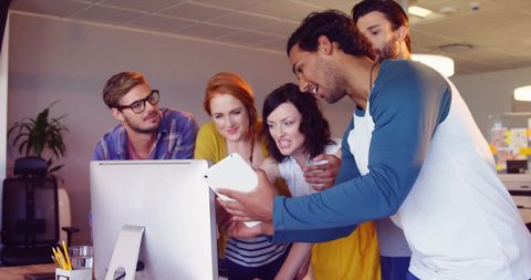 Diverse Team Engaged in Collaborative Idea Sharing in Office