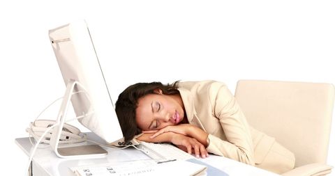 Tired businesswoman sleeping at desk in office attire