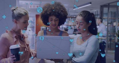 Diverse Team Collaborating with Laptop and Digital Media Icons in Office