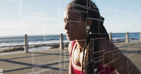 Focused runner jogging along coastal promenade with augmented reality fitness overlays