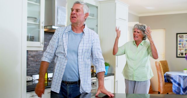 Senior Couple Having Argument in Modern Kitchen - Download Free Stock Images Pikwizard.com