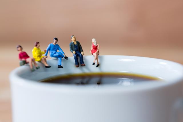 Conceptual image of miniature group of friends having coffee