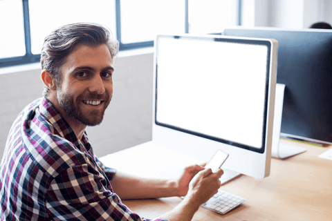smiling professional holding phone by blank transparent monitor - Download Free Stock Videos Pikwizard.com