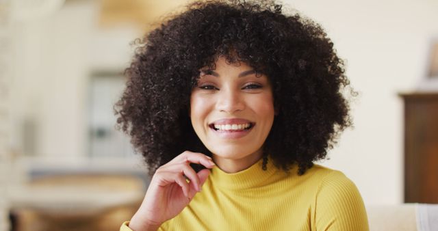 Portrait of african american woman smiling in living room - Download Free Stock Photos Pikwizard.com