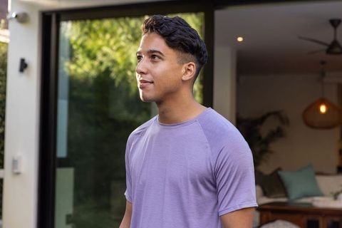 Man Gazing Outside Living Room Glass Door in a Contemporary Home