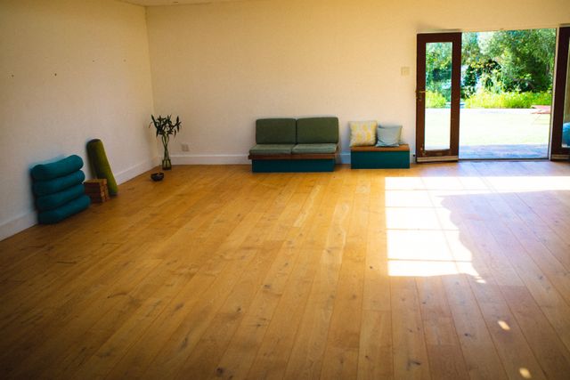 Interior of empty yoga studio with hardwood floor, copy space. unaltered, absence, fitness, yoga and healthy lifestyle.