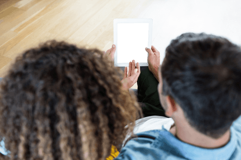 Couple viewing transparent digital tablet together concept