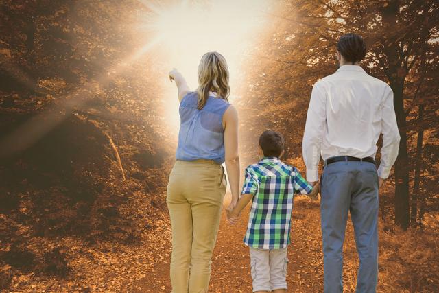 Digital composite of Woman pointing at sunlight while standing with family