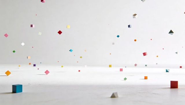 Floating colorful cubes and tiny geometric solids on minimal white surface for modern ui