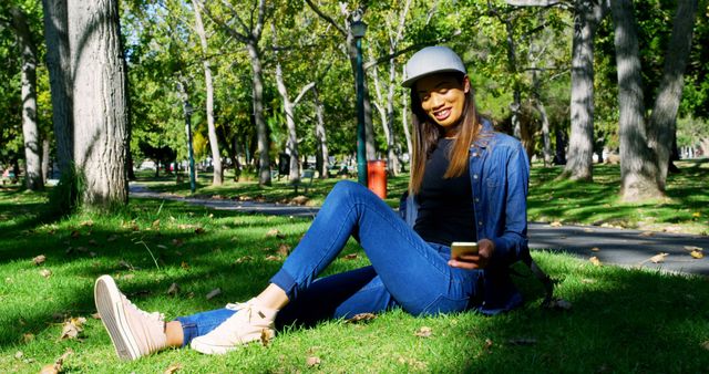 Woman Relaxing on Grass in Sunny Park with Smartphone - Download Free Stock Images Pikwizard.com