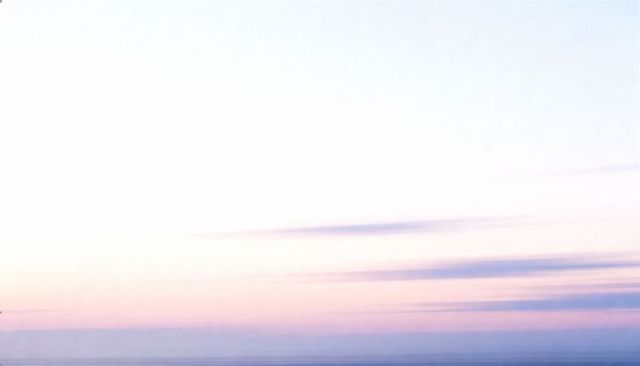 Lavender sunrise over calm sea creating soft pastel minimalist horizon background