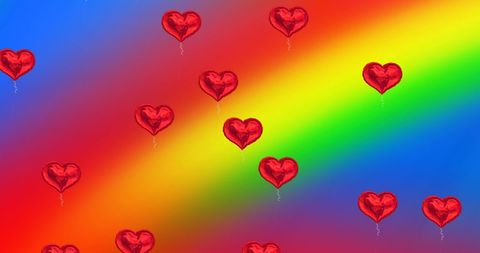 Heart balloons floating against rainbow gradient backdrop