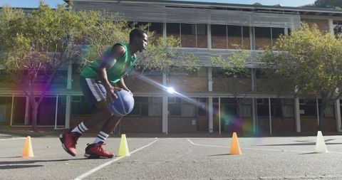 Athlete Dribbling Basketball Around Cones on Outdoor Court