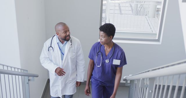 African american male and female doctors talking at hospital - Download Free Stock Photos Pikwizard.com