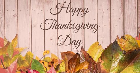 Thanksgiving Greeting with Autumn Leaves and Wooden Background