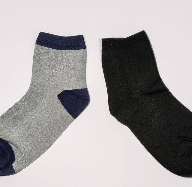 Close up of black and grey socks on white background. Fashion, design and clothes concept.