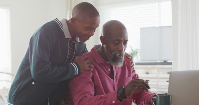 Grandfather and Grandson Bonding over Computer Activities at Home - Download Free Stock Images Pikwizard.com