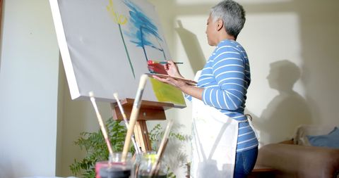 Senior Woman Engaged in Painting on Large Canvas at Home - Download Free Stock Images Pikwizard.com