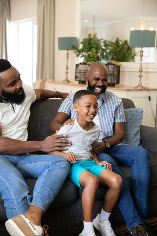 Happy family bonding on living room sofa