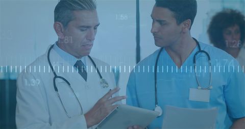 Medical Professionals Consulting in Hospital on Digital Records