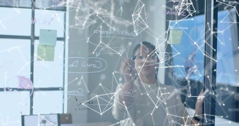 Professional Female Innovator Sketching Network Concepts on Glass