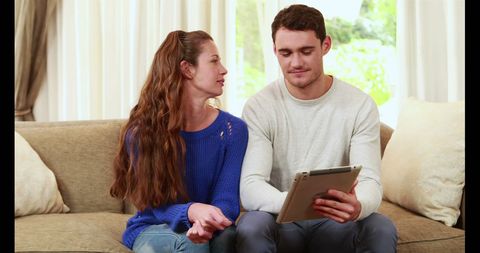Caucasian Couple Using Tablet on Couch in Bright Living Room - Download Free Stock Images Pikwizard.com