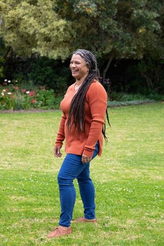 Joyful woman walking in green park enjoying nature