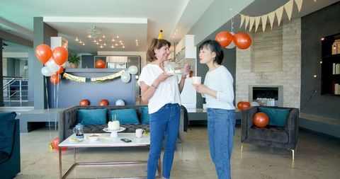 Senior Friends Enjoying Birthday Celebration with Cake and Coffee