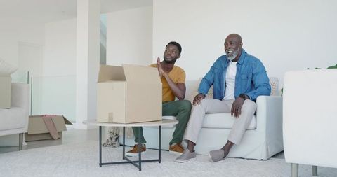 Father and Son Bonding While Unpacking at Home