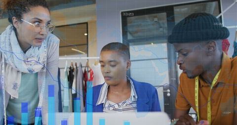 Creative fashion design team analyzing data in studio