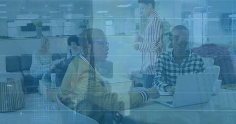 Financial data overlay with diverse business team collaborating in modern office