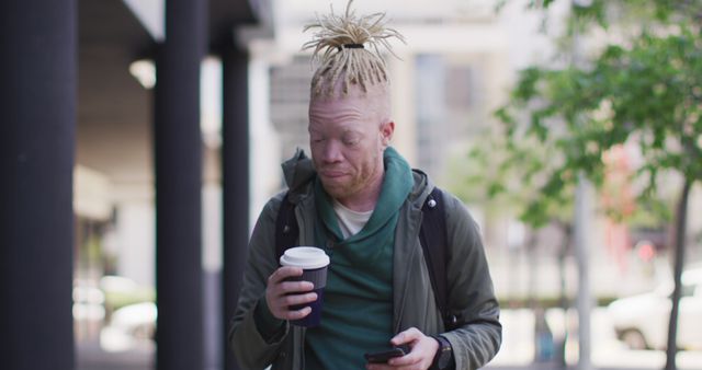 Young Man With Coffee Scrolling Through Smartphone Outdoors in City - Download Free Stock Images Pikwizard.com