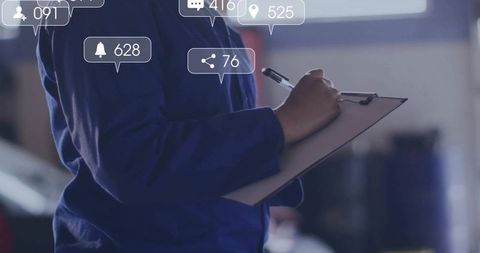 Technician Holding Clipboard and Writing in Workshop with Notifications