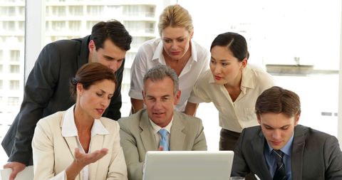 Business Team Collaborating around Laptop in Office Setting - Download Free Stock Images Pikwizard.com