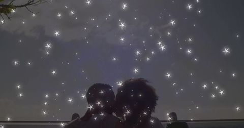 Silhouetted Couple Embracing under Starry Night Sky