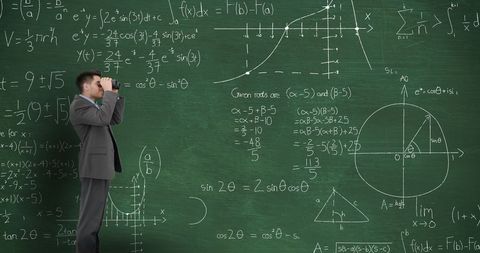 Man in suit analyzing chalkboard of complex math equations
