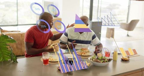 Two men sharing casual lunch at kitchen island while viewing augmented reality analytics