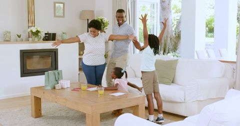 Family Enjoying Creative Playtime at Home on Relaxing Day
