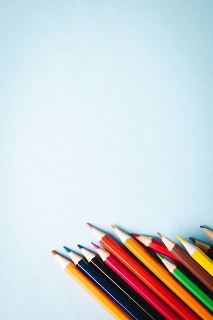 This image features a collection of colored pencils arranged on a blue background with ample copy space. Ideal for use in educational materials, back-to-school promotions, art and craft advertisements, and stationery product displays. The vibrant colors and clean background make it perfect for creative and professional presentations.